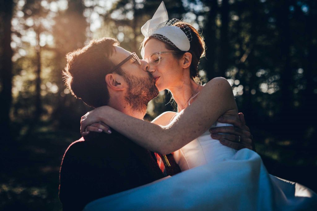 Boconnoc House woodland bride and groom kiss