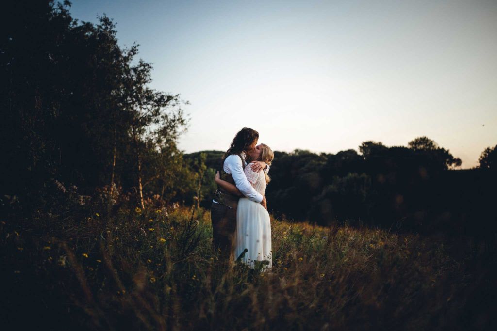 Bride and groom at dusk at a festival wedding in devon